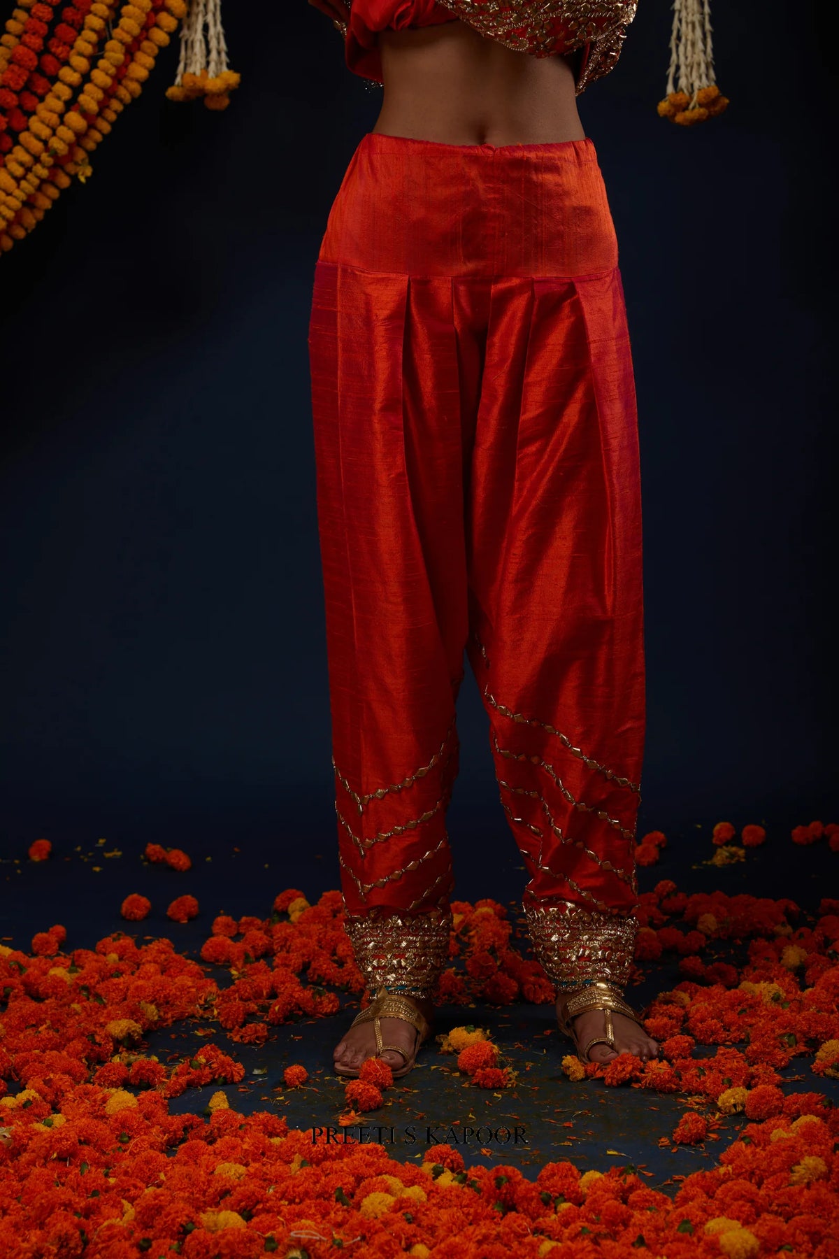Close-up of gathered Rust Red salwar with gold embroidered ankle cuff – Preeti S Kapoor