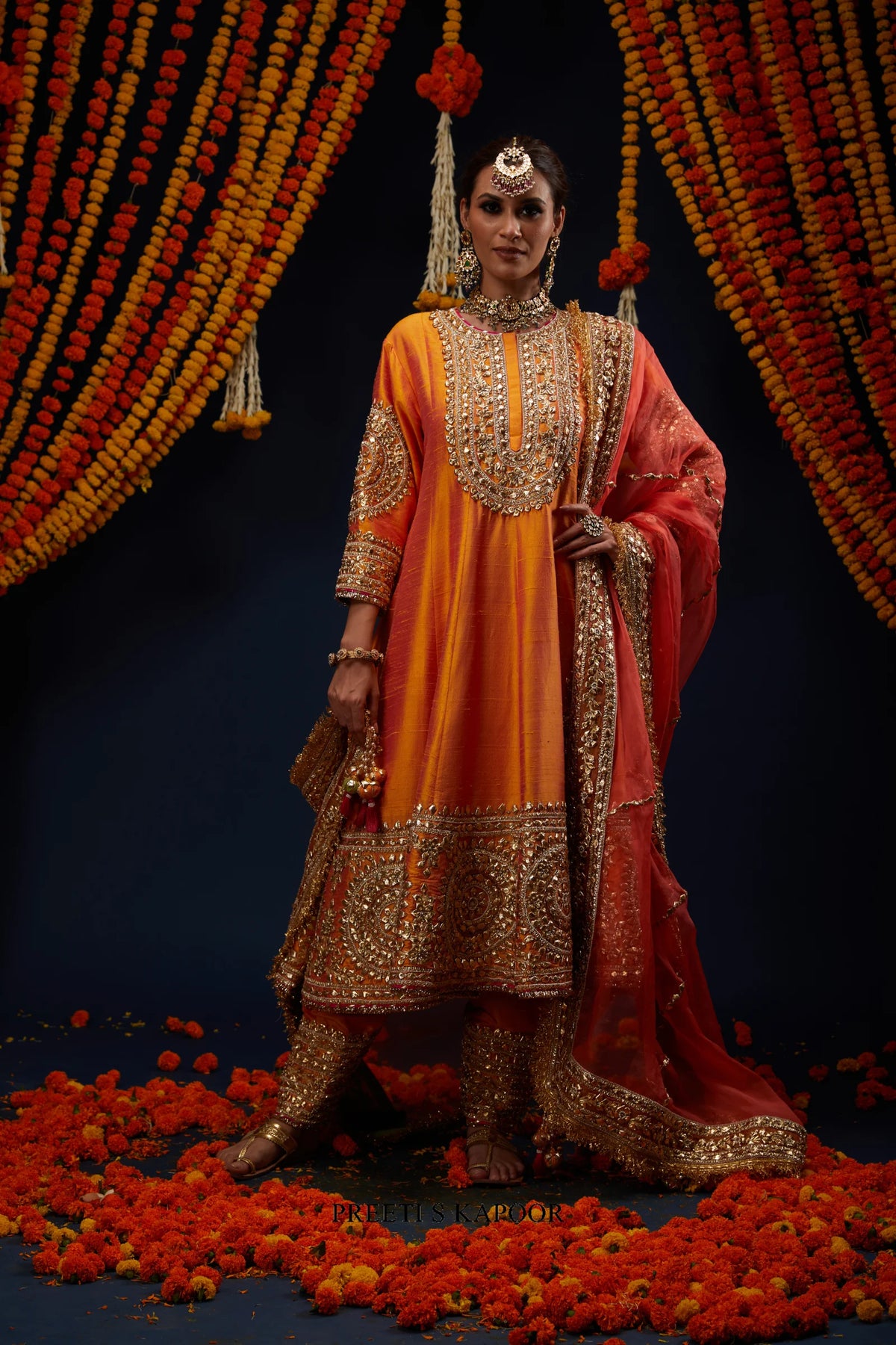 Woman wearing Marigold Orange raw silk Anarkali with gold embroidered salwar – Preeti S Kapoor