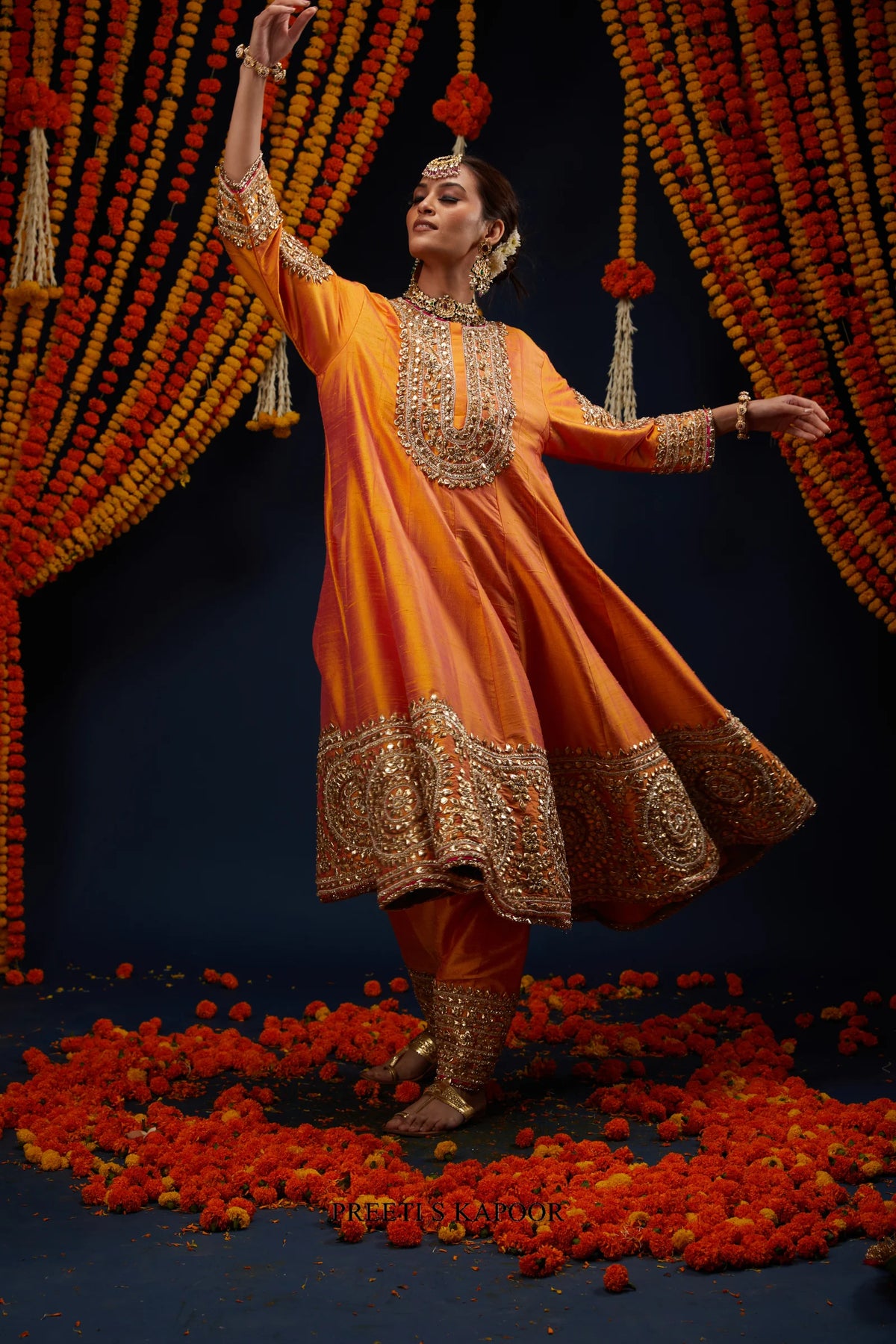 Woman twirling in Marigold Orange gold embroidered kurta salwar set – Preeti S Kapoor