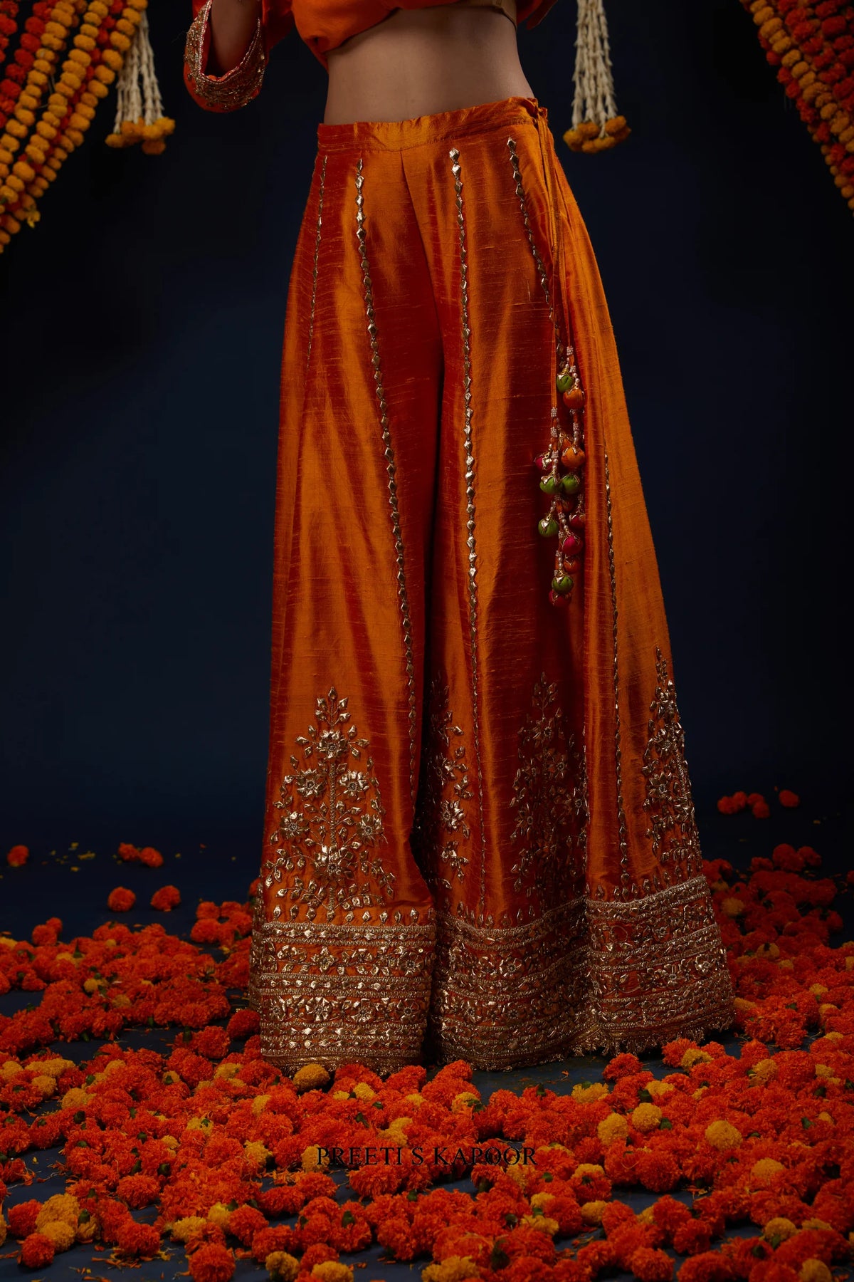 Close-up of Orange raw silk sharara with gold floral embroidery – Preeti S Kapoor