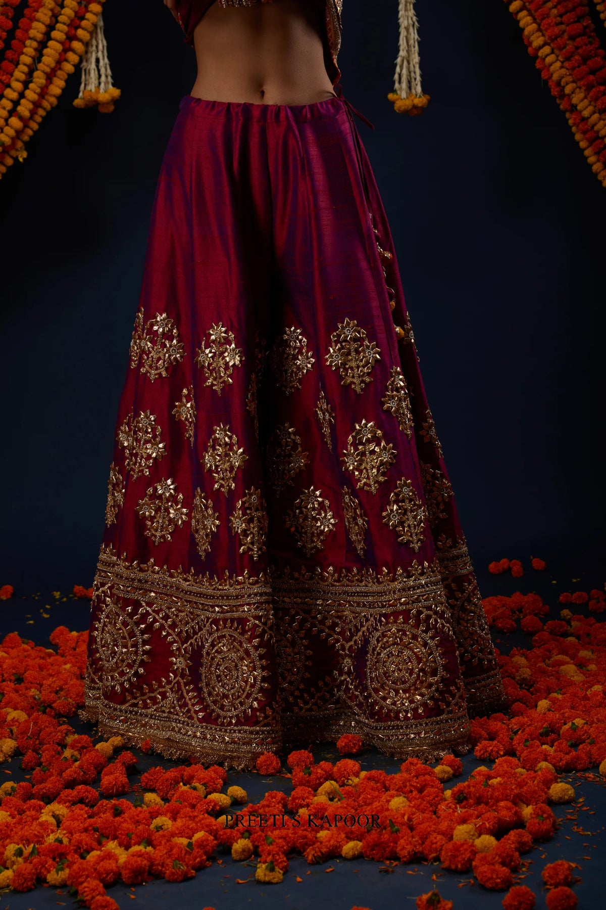 Close-up of Wine Magenta raw silk sharara with floral gold embroidery – Preeti S Kapoor