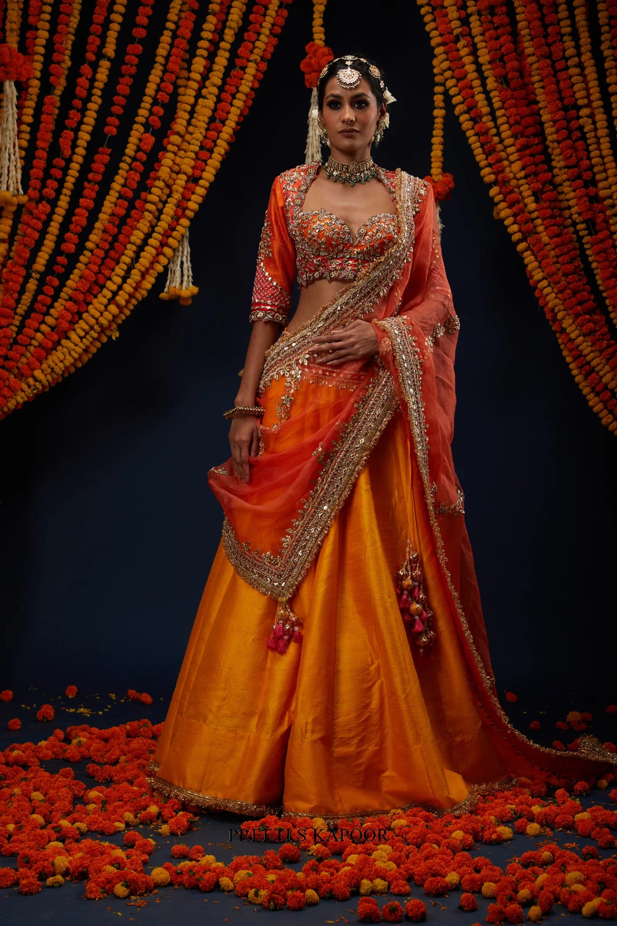 Woman wearing Marigold Yellow raw silk lehenga with Rust Red ombre blouse – Preeti S Kapoor